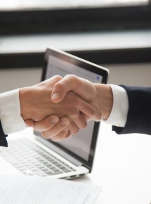 Businessman handshaking businesswoman as concept of good business deal and respect for new partner, successful partnership and great teamwork, hiring, close up view of male female hands shaking